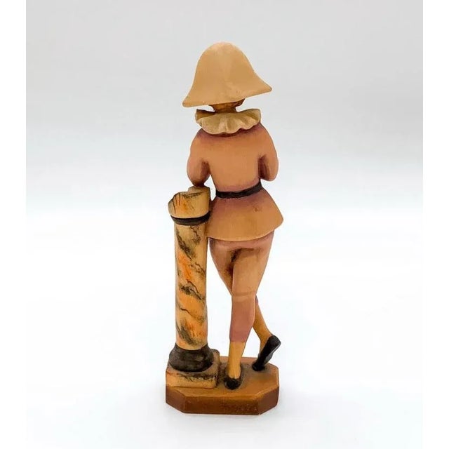 Depicts young man holding a rose in both hands while leaning against a pillar. ANRI backstamp. Marked 313/2500.