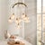 Light and airy, this chandeliers composition is simple: nine blown glass shades, warm antiqued brass iron, and plenty of...