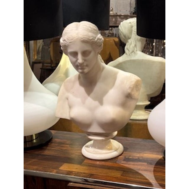 The product is a 19th-century French carved bust of Diana, a sculpture depicting the ancient Roman goddess. This...