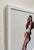 This oil painting depicts a figure seated on the steps, embodying a moment of quiet contemplation. The play of light and...