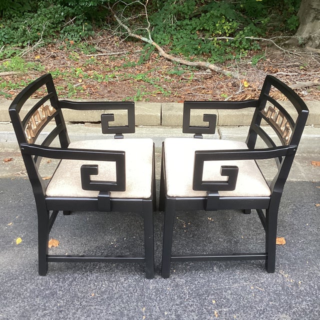 Striking set of ten dining chairs, beautifully restored in high-gloss black lacquer with refined gold detailing and subtly...