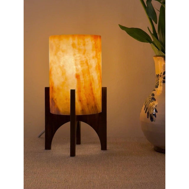 Comet pairs a hand-carved Egyptian alabaster shade with a geometric walnut base, combining contemporary form with...