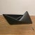 A striking mid-century Japanese ceramic ikebana vessel with a bold, origami-inspired silhouette. Crafted in matte black...
