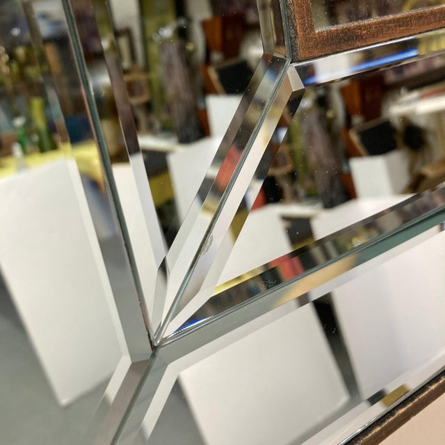 Modern chic wall mirror with multiple panes of beveled mirrored glass. Wood frame. Stepped design creates an optical...
