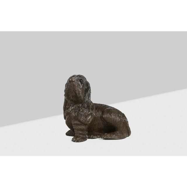 Carved basswood dog, Black Forest style. Circa 1900. This piece is designed in the style of the selected designer and/or...