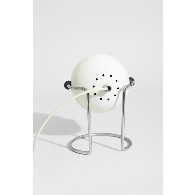 1970s lamp with adjustable shade in a soft matte finish, cradled by a streamlined chrome frame. Designed by Targetti...