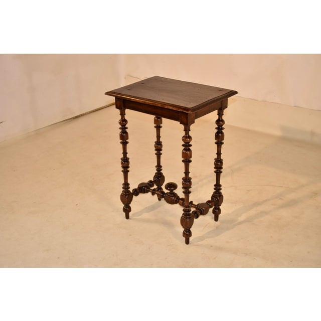 18th century period Louis XV walnut side table from France. The top is made from a single plank and has beveled edges,...