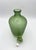 Bottle from the Incisi series designed by Paolo Venini for the Venini glassworks. This green bottle with a heavy stopper...