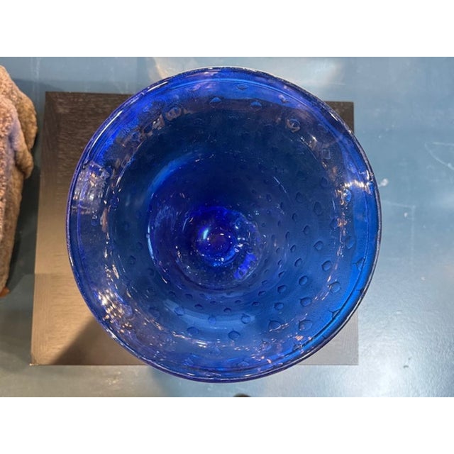The Vintage Cobalt Blue and Gold Murano Glass Vase is a stunning piece of decorative pottery and glassware. Made by the...