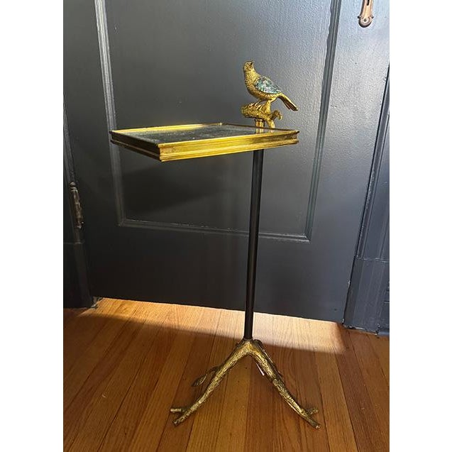 You’ll not find another drink table like this. This is brass drink table with the handle for the table being a bird...