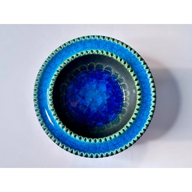 This high-quality ceramic bowl was handcrafted in Italy around 1960. It features a detailed decor and an impressive inlay...