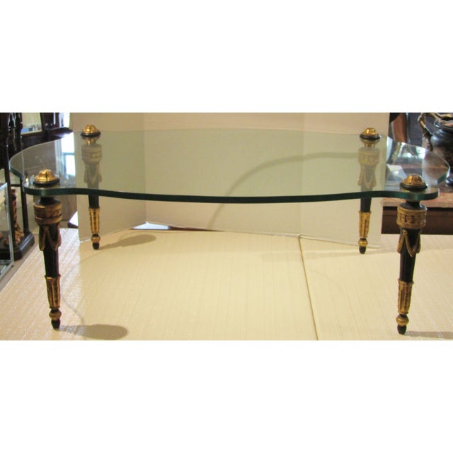 This Rare Italian hand-carved wood cocktail table from the 1960s features a unique free-form shape and a glass top, adding...