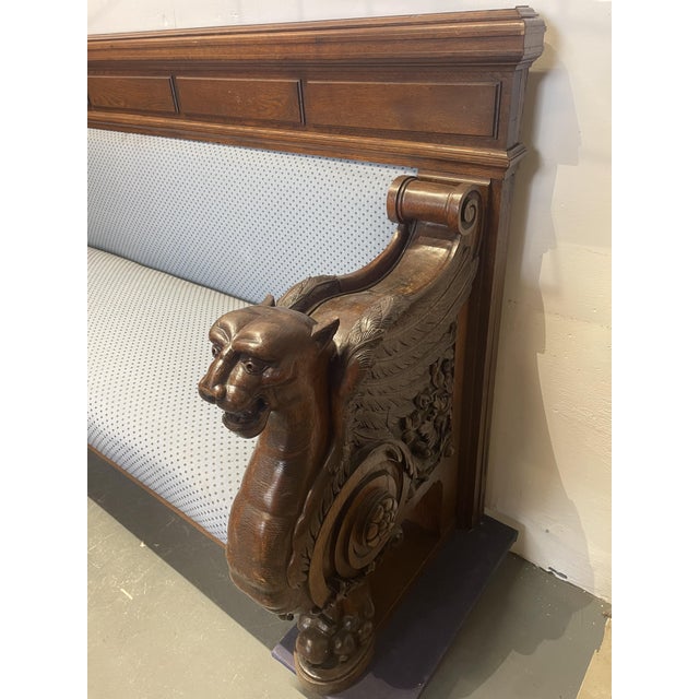 Very solid antique German oak bench with armrests in the form of carved griffins, circa 1890.
