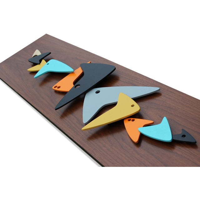"SKooL" Handmade Painted Wood Wall Art This abstract school of multi-colored boomerangs float on a substantial and...