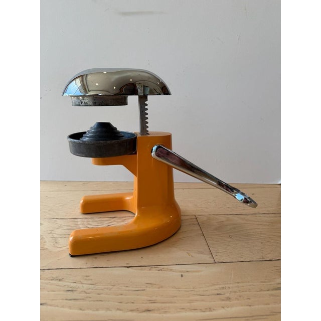 Ramcon Deluxe Manual Citrus Juicer. This stunning mid-century modern kitchen tool features a vibrant orange enamel body...