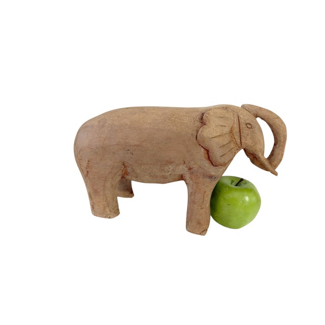 Vintage Hand Carved Wood Elephant With Tusks measures 10.5" d by 3.75"w by 6.75" H. This handmade wooden sculpture likely...