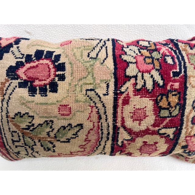 Decorative pillow upholstered in a 19th century Kerman rug fragment, featuring charming floral flowerhead motifs and an...