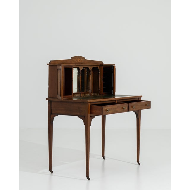 A distinguished example of Edwardian craftsmanship, this secretary desk embodies the era's characteristic refinement — a...