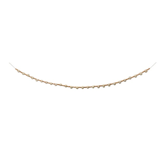 Add a touch of natural elegance to your holiday decor with this beautiful set of Wood Beaded String Garlands. Measuring...