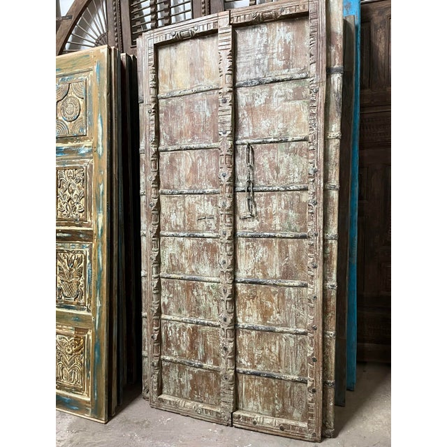 Elevate your space with the timeless beauty of this antique carved teak wood door, a stunning architectural piece rich...
