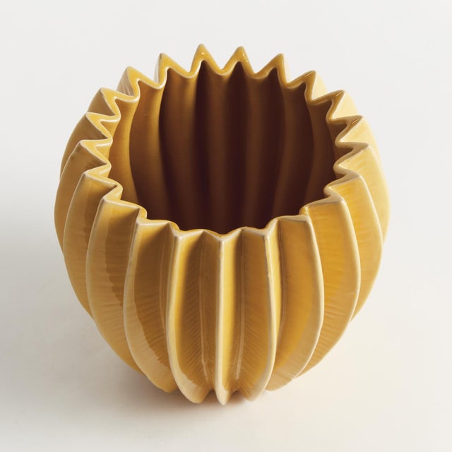 With a rounded form, deep ribbing and thickly applied glaze, this natureinspired pot is a work of art. The handfinished...