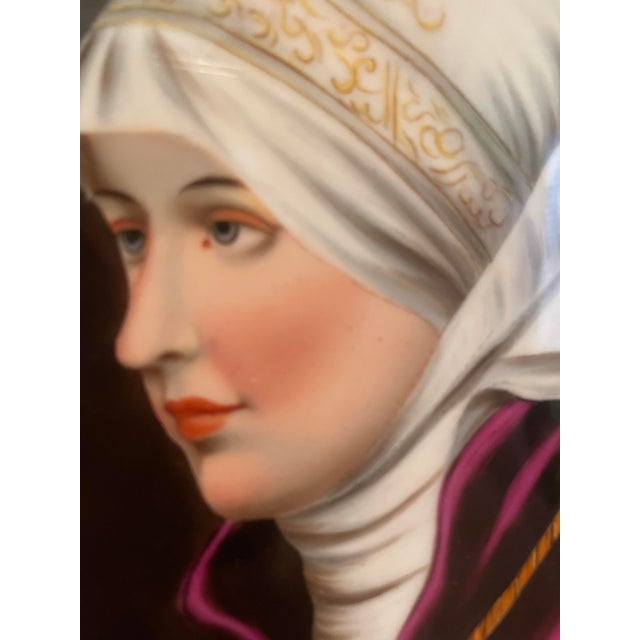 An exquisite 19th-century European hand-painted miniature porcelain portrait plaque depicting the iconic Roman noblewoman...
