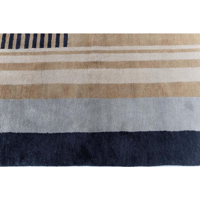 This modern Deco-inspired geometric rug showcases a refined composition of clean lines and architectural forms, creating a...