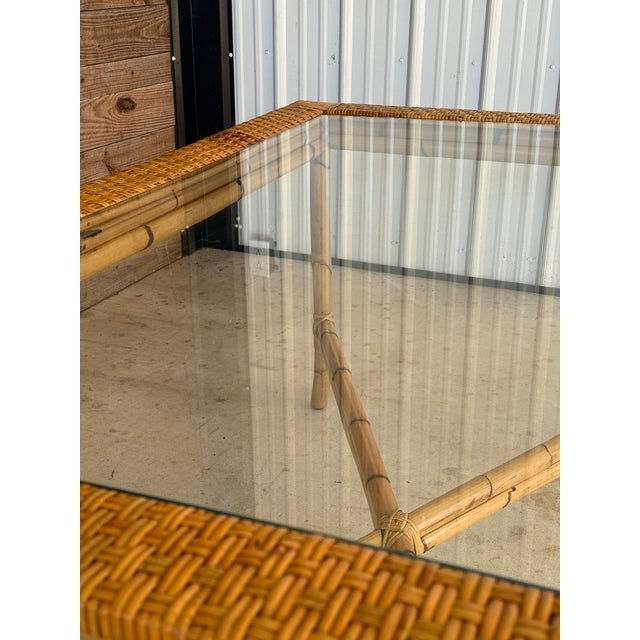 Beautiful vintage rattan dining table featuring an organic modern silhouette with warm honeyed tones and classic...