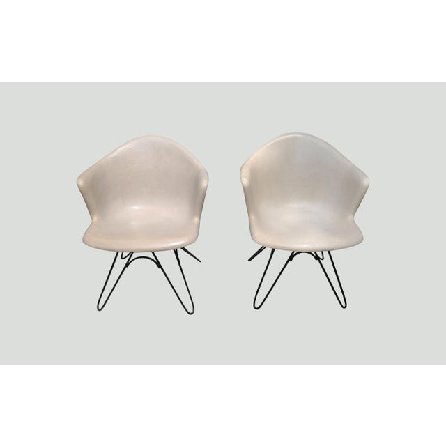 The boomerang angles of these mid century modern fiberglass chairs are reminiscent of the Lawrence Peabody wingback...
