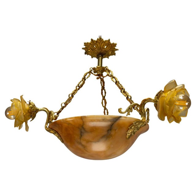French Neoclassical chandelier, circa 1920. Featuring a richly veined amber-toned alabaster bowl with finely cast bronze...