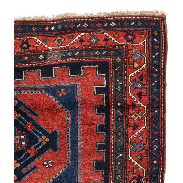 This lovely antique Caucasian Kazak carpet measures 4.7 x 7 ft and is from the 1930s.