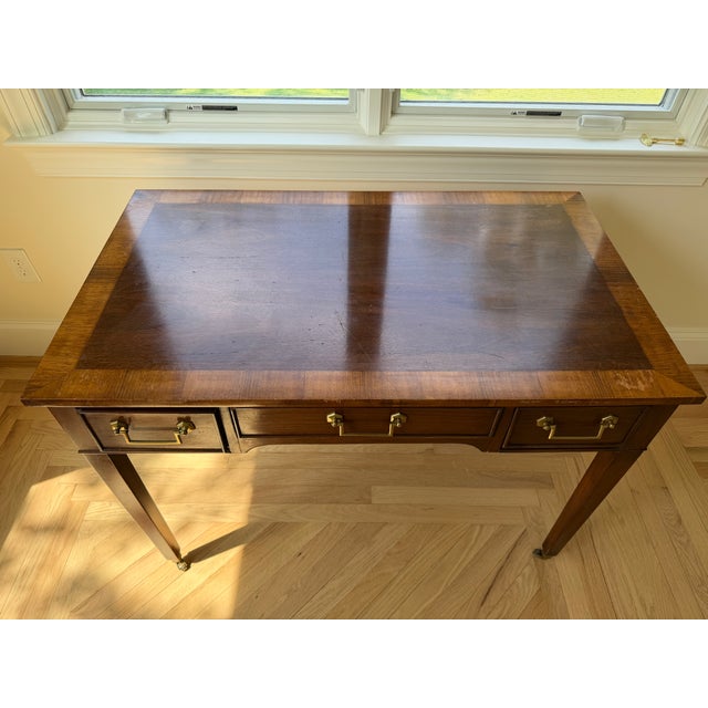 Solid wood writing desk with three drawers (clean and slide easily) featuring brass hardware. Tapered legs with brass...