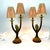 A striking and whimsical pair of vintage table lamps featuring sculptural parrot figures integrated into elegant double...