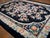 Antique Floral Medallion Wool Hand Knotted Pile Black 1920s Rug, Circa Date: 1920s. This exceptional example of Art Deco...