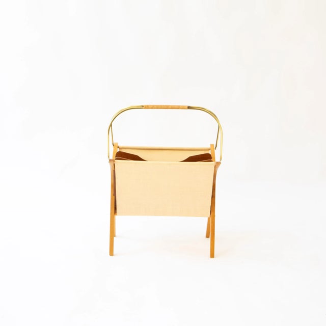 Simple and elegant, this magazine rack was created around 1950 in the tradition of Atelier Auböck's designs. Crafted from...