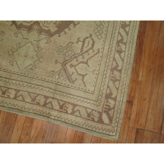 An antique Turkish Oushak rug in taupe, beige and brown accents. Recommended for an entry / foyer space, circa 1920s....