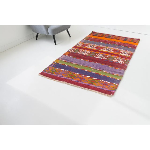 This is a vintage Turkish Oushak rug from the Mid 20th Century. The piece was hand-knotted.