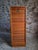 This vintage oak roll top cabinet was made in France during the 1960s–1970s. Originally used in an office, it is now well...