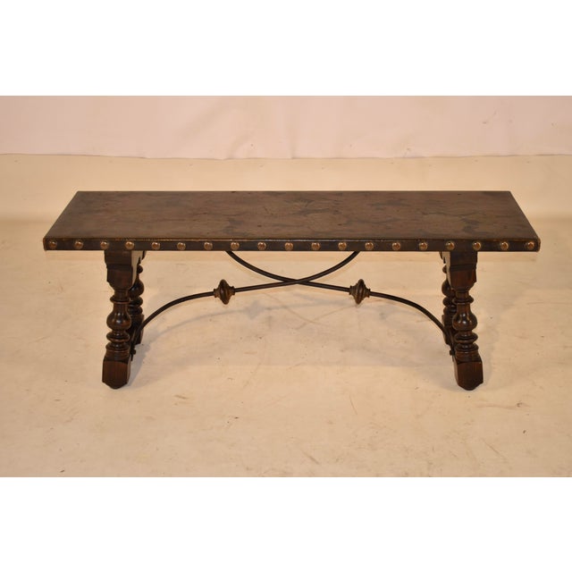 1920's Continental walnut bench in the Spanish Revival style. The top is lovely and is covered in hand painted canvas,...