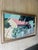 A vibrant vintage painting by Haitian artist Phillip “Fillmore” Outten depicting a charming architectural landscape with a...