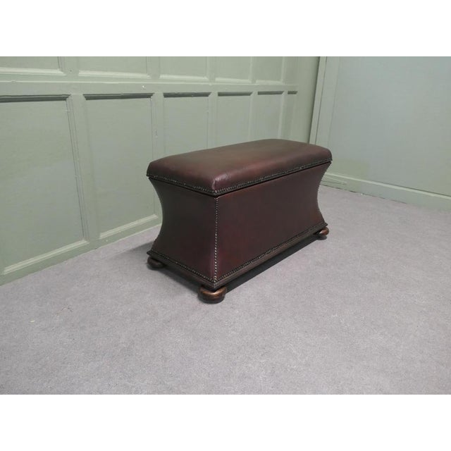 A Large Regency Waisted Leather Ottoman or Window Seat The ottoman is upholstered with soft leather and the inside is...