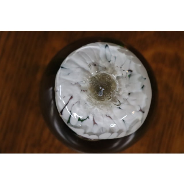 Handcrafted art glass paperweight featuring a dimensional pink rose with green leaves encased in clear crystal. The floral...