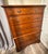 Later 20th Century Stanley Furniture “Open Home” highboy dresser. Warm wood finish with a decorative carved frieze detail...