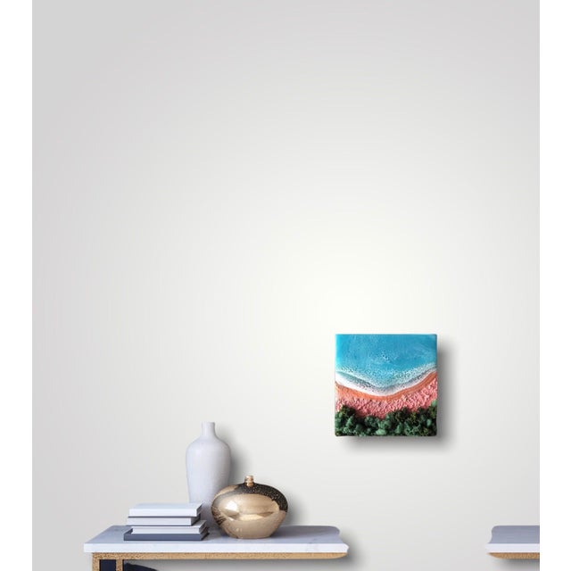 This mixed media artwork captures a vibrant beach scene, where the foam of the waves meets a textured sandy shore. The...