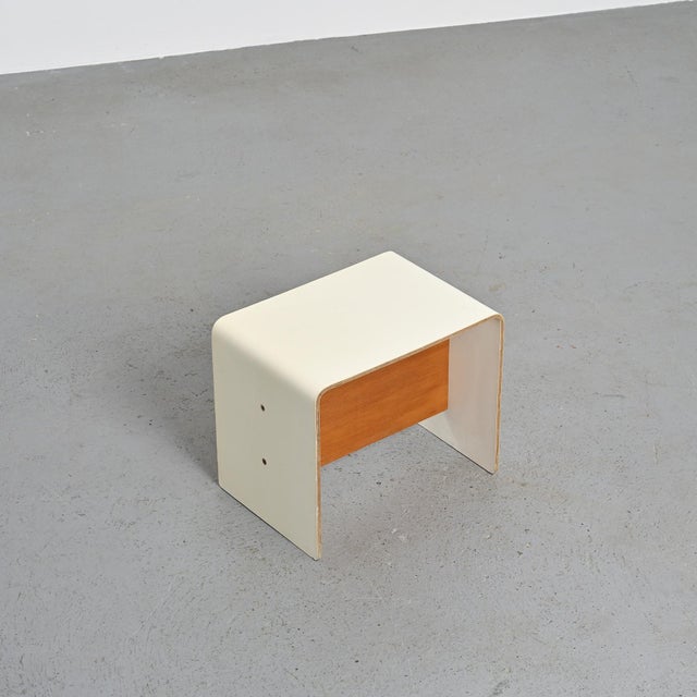 Bedside table designed by Pierre Guariche for apartments in La Plagne and Bandol. Made of U-shaped bent plywood, covered...