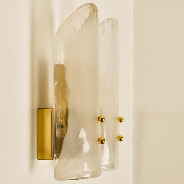 High-end wall sconces made of blown clear and opal murano glass on a messing hardware. Designed and produced by j.t....