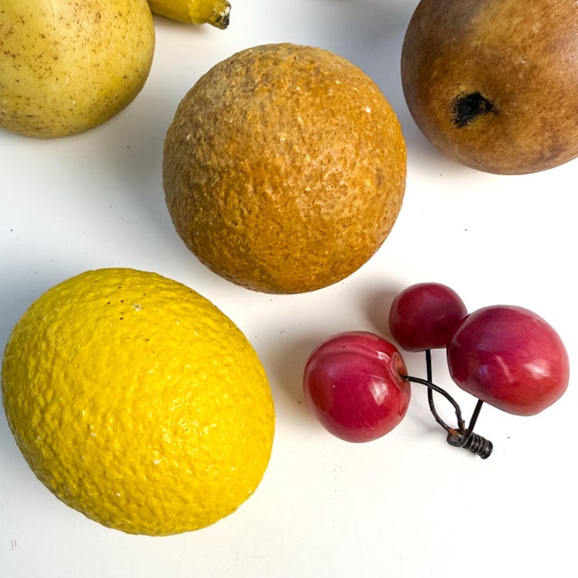 A richly colored collection of 10 vintage decorative stone fruits, assembled as a tabletop still life. The set includes a...