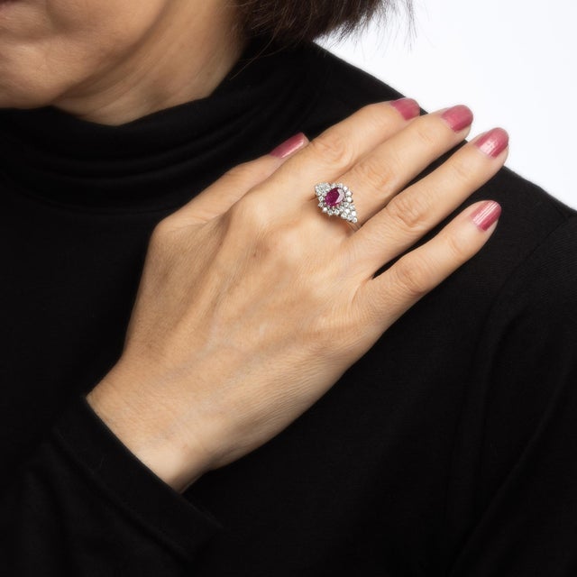 Stylish ruby & diamond cocktail ring crafted in 14 karat white gold. Oval faceted ruby measures 8mm x 6mm, accented with...