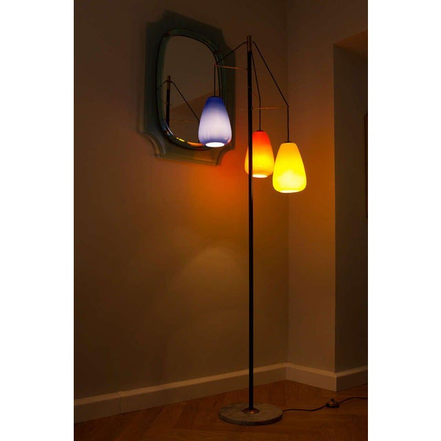This floor lamp features Murano glass lamp shades, brass and black lacquered metal, and a marble base. I have official...