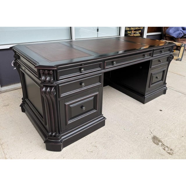 The Hooker Furniture Telluride Executive Desk makes an impressive statement with its black finish over cherry veneers,...
